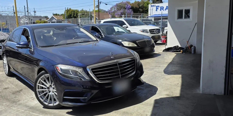 Three Mercedes-Benz cars parked outside the shop